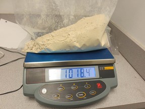 More than a kilogram of heroin seized by Canada Border Services Agency sits on a scale at Calgary Airport on Nov. 22, 2018. Border guards intercepted a woman who had heroin concealed in her suitcase. The woman also ingested a large amount of the drug.
