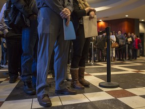 Hundreds of hopeful applicants wait in line at a Calgary jobs fair in 2015.