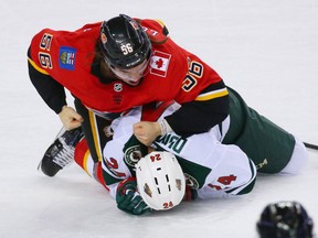 The Calgary Flames' Ryan Lomberg retaliates against the Minnesota Wild's Matt Dumba during NHL action at the Scotiabank Saddledome in Calgary on Thursday December 6, 2018. Gavin Young/Postmedia