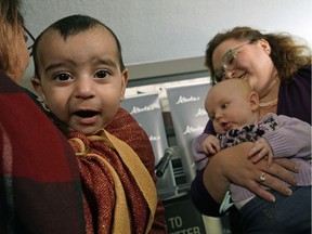 Alberta Health Minister Sarah Hoffman (right) announced Dec. 12, 2018 that the Alberta government has expanded midwives' scope of practice. Hallaj Versi-Sumar (left, six-months-old) and Emersyn Durand (four-months-old) were on hand at the Lucina Birth and Family Wellness Centre in Edmonton.