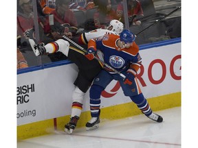 Edmonton Oilers Kyle Brodziak (28) upends Calgary Flames Mark Jankowski (77) during second period NHL action on Sunday, Dec. 9, 2018, in Edmonton.