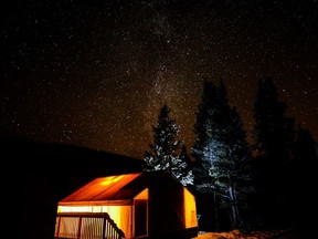 An image of a glamping tent at Mount Engadine Lodge at night with a starry night sky - Winter Glamping at Mount Engadine Lodge