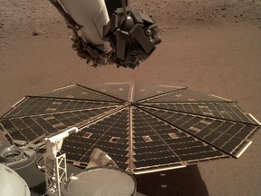 This Friday, Dec. 7, 2018 photo made available by NASA shows a view from the arm-mounted camera on the InSight Mars lander. The spacecraft arrived on the planet on Nov. 26. (NASA/JPL-Caltech via AP)