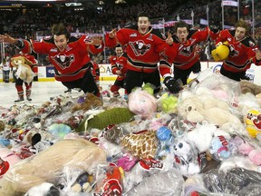 Calgary Hitmen have some fun with the thousands of teddy bears during the 24th annual Brick Teddy Bear Toss game against the Kamloops Blazers at the Scotiabank Saddledome in Calgary on Sunday December 9, 2018. Darren Makowichuk/Postmedia