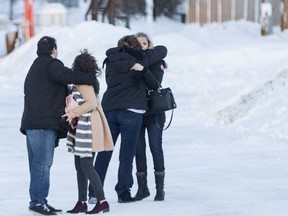 Members of the Wassermann and Dahlgren family, with other, hug prior to entering the Kerry Vickar Centre, which is being used for the sentencing hearing, in Melfort, Sask. on Monday, Jan. 28, 2019.