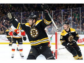 Jake DeBrusk #74 of the Boston Bruins celebrates after John Moore #27 scored a goal during the game between the Boston Bruins and Calgary Flames at TD Garden on Thursday in Boston.