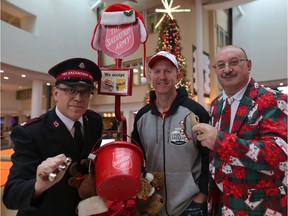 Major Al Hoeft of the Salvation Army and Cluny Randell, right with Calgary Stampeders head coach Dave Dickenson during the Salvation Army Christmas Kettle Campaign at Chinook Mall in Calgary, on Friday December 14, 2018. Leah Hennel/Postmedia