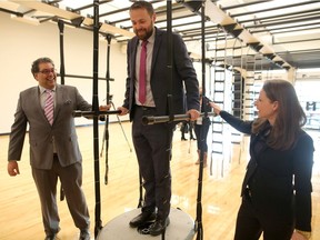 Mayor Naheed Nenshi, MLA Graham Sucha and YMCA president Shannon Doram tour one of the workout rooms at Brookfield Residential YMCA at Seton in Calgary, on Thursday, Jan. 10, 2019.