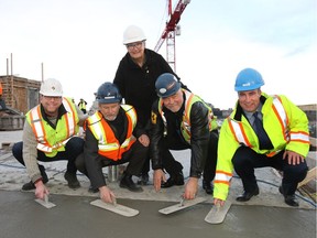 Marking the topping off ceremony at Avli are, from left, Coun. Gian Carlo Carra, Chris Stathonikos, Penny Stathonikos, Calvin Buss and Brian Kernick.