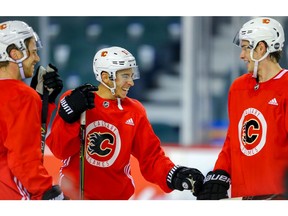 Calgary Flames Johnny Gaudreau (middle) shares a laugh with teammates Elias Lindholm and Sean Monahan during practice on Monday, October 1, 2018. Al Charest/Postmedia