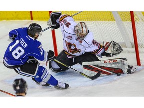 Hitmen goalie Jack McNaughton makes a save on a shot by Tarun Fizer of the Victoria Royals during WHL hockey at the Scotiabank Saddledome in Calgary on Tuesday, January 1, 2019. Al Charest/Postmedia