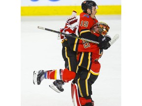Calgary Flames Matthew Tkachuk and David Rittich celebrate after defeating the Colorado Avalanche during NHL hockey at the Scotiabank Saddledome in Calgary on Wednesday. Photo by Al Charest/Postmedia.