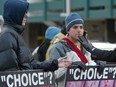 A passerby engages in  debate with anti-abortion protestors in Calgary affiliated with the Canadian Centre for Bio-Ethical Reform. Herald files
