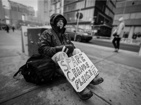 A homeless individual named Tom looks for spare change along Centre Street in downtown Calgary. Gavin Young/Postmedia