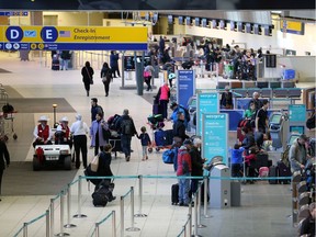 Passengers check in at the departures level at Calgary International Airport.