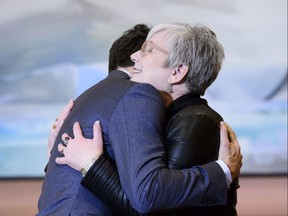 Prime Minister Justin Trudeau hugs Minister of Rural Economic Development Bernadette Jordan at a swearing in ceremony at Rideau Hall in Ottawa on Monday, Jan. 14, 2019.