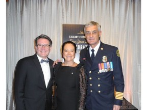 Looking fabulous at the Calgary Firefighters New Year's Eve Celebration at Hotel Arts in support of the Firefighters' CF2 SAFE program and the Calgary Herald  Christmas Fund are, from left: Calgary Herald editor Lorne Motley; event chair Ann McCaig; and Fire Chief Steve Dongworth.