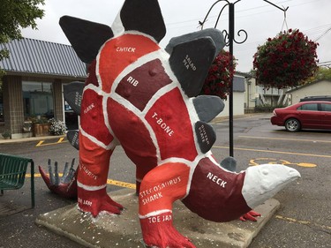 A stegosaurus statue in front of a butcher shop in Drumheller, Alta., that would make Fred Flintstone drool. (Provided / DinoArts Association)