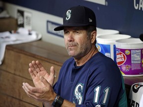 In this Aug. 10, 2017, file photo, Seattle Mariners hitting coach Edgar Martinez applauds in the dugout before a baseball game against the Los Angeles Angels in Seattle. AP file photo.