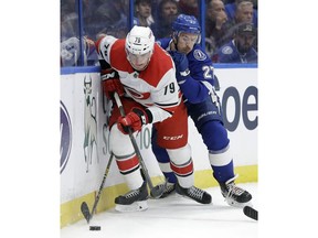 Carolina Hurricanes left wing Micheal Ferland (79) and Tampa Bay Lightning defenseman Ryan McDonagh (27) battle for the puck during the first period of an NHL hockey game Thursday, Jan. 10, 2019, in Tampa, Fla.