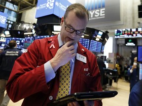 Trader William Lawrence works on the floor of the New York Stock Exchange, Thursday, Jan. 3, 2019. Apple's shock warning that its Chinese sales are weakening ratcheted up concerns about the world's second largest economy and weighed heavily on global stock markets as well as the dollar on Thursday. (AP Photo/Richard Drew)