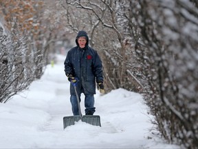 An elderly man who declined to give his name clears sidewalks in Crescent Heights on Thursday, January 17, 2019. The man said he regularly cleared the sidewalk in front of his home and four others on his block. Gavin Young/Postmedia