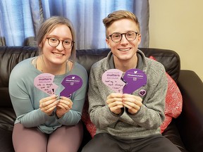 Sydney Rankin and Benjamin Palmer from the University of New Brunswick Student Union show the broken hearts that students will fill out and display on campus walls during the #StudentsLetAct campaign, and which will be presented to the federal government as part of a push for further mental health supports.