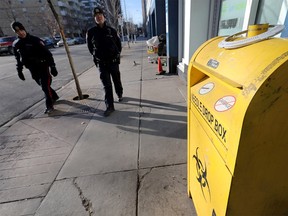 Police patrol the sidewalk outside the Sheldon M. Chumir Health Centre on Jan. 29, 2019.