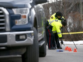 Police investigate the scene after a pickup truck struck a woman as she walked her dog at the intersection of 5th Street and 26th Avenue N.W. on Wednesday, Jan. 9, 2018.