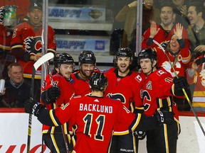 Flames celebrate a goal by Michael Frolik against the Florida Panthers at the Saddledome on Friday, Jan. 11, 2019.