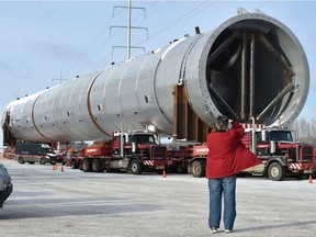 Denise Trent of Tofield came out especially to photograph a petrochemical vessel, called a propylene-propane splitter, because she won't be home when it travels past her house. It is the heaviest load to ever hit Alberta's highways and is parked off Highway 14 just east of Highway 21 on Monday, Jan. 7, 2018 as it starts its four-day crawl to Fort Saskatchewan.