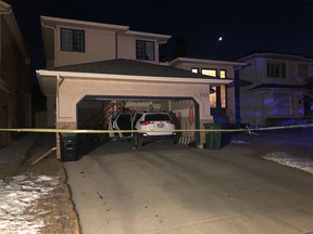 A home is taped off as the Calgary police homicide unit investigates a death in the city's northwest.