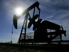 A pumpjack works in a field near Devon, Alta.