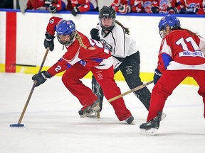 The Calgary Rush's Kaitlen Hetland, left, and Campton Hancock control the ring in front of the LMRC Thunder's Elise Piovesan during Esso Golden Ring U19AA ringette action at the Stew Hendry Arena on Saturday, Jan. 19, 2019.