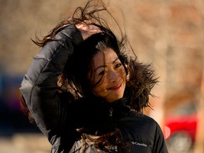 Wind blows Lisa Castro's hair as she walks to work  in Calgary, on Friday, Jan. 4, 2019.