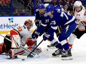 TAMPA, FLORIDA - FEBRUARY 12: David Rittich #33 of the Calgary Flames stops a shot from Adam Erne #73 of the Tampa Bay Lightning during a game  at Amalie Arena on February 12, 2019 in Tampa, Florida. (Photo by Mike Ehrmann/Getty Images)