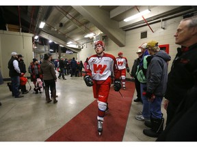 Calgary Hitmen players walk to the team dressing room at the Corral before they play the Prince Albert Raiders at the Corral in Calgary on Friday night. Photo by Leah Hennel/Postmedia.