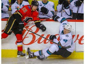 Calgary Flames Sam Bennett collides with Tomas Hertl of the San Jose Sharks during NHL hockey at the Scotiabank Saddledome in Calgary on Monday, December 31, 2018. Al Charest/Postmedia