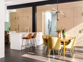 A striking lighting fixture above the dining table in a home in University Heights designed by Alloy Homes with interior design by Aly Velji.