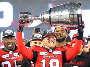 Calgary Stampeders quarterback Bo Levi Mitchell hoists the Grey Cup after defeating the Ottawa Redblacks on Nov. 25, 2018.