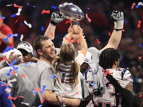 Tom Brady of the New England Patriots celebrates with daughter Vivian, who raises the Vince Lombardi Trophy, after Super Bowl LIII at Mercedes-Benz Stadium on February 3, 2019 in Atlanta. (Mike Ehrmann/Getty Images)