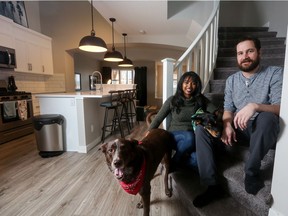 Mary Llaneta and Brandon Potts, with their two dogs Trip and Tuck, love the roominess of their new home in Seton.
