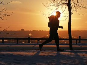 The sun sets as a runner heads home along Crescent Road at sunset on another cold day in Calgary, Tuesday February 5, 2019.  Gavin Young/Postmedia