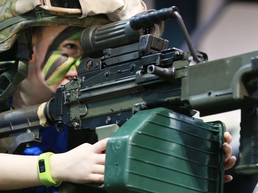 Joshua Keyes tries out some of the equipment of the King's Own Calgary Regiment at the Calgary Boat and Outdoors Show at the BMO Centre on Thursday February 7, 2019. The show continues through the weekend.