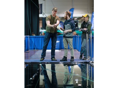 Visitors get fly fishing casting tips from Out Fly Fishing Outfitters at the Calgary Boat and Outdoors Show at the BMO Centre on Thursday February 7, 2019. The show continues through the weekend.