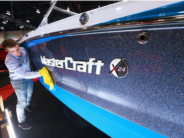 Spencer Shaw does some detailing on one of the boats at the Calgary Boat and Outdoors Show at the BMO Centre on Thursday February 7, 2019. The show continues through the weekend.