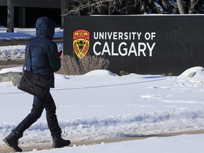 Students walk past a sign at the south entrance to the University of Calgary on Tuesday February 26, 2019. U of C students have already seen their tuition rise, but other post-secondary students in the city are still waiting to hear how much more they will pay.