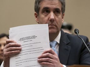 Michael Cohen, President Donald Trump's former personal lawyer, finishes reading his opening statement as he testifies before the House Oversight and Reform Committee on Capitol Hill in Washington, Wednesday, Feb. 27, 2019.