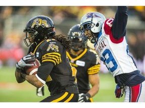 Hamilton Tiger-Cats Courtney Stephen and Montreal Alouettes Duron Carter at Tim Hortons Field during 2nd half CFL Eastern Final in Hamilton, Ont. on Sunday November 23, 2014. Ernest Doroszuk/Toronto Sun/QMI Agency