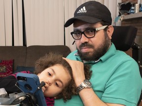 Quebec City mosque shooting victim Aymen Derbali and his daughter Maryem are shown in their home in Quebec City, Thursday, Jan. 24, 2019. Two victims of the Quebec City mosque shooting are among eight Quebecers honoured today by the provincial government for their acts of courage.THE CANADIAN PRESS/Jacques Boissinot